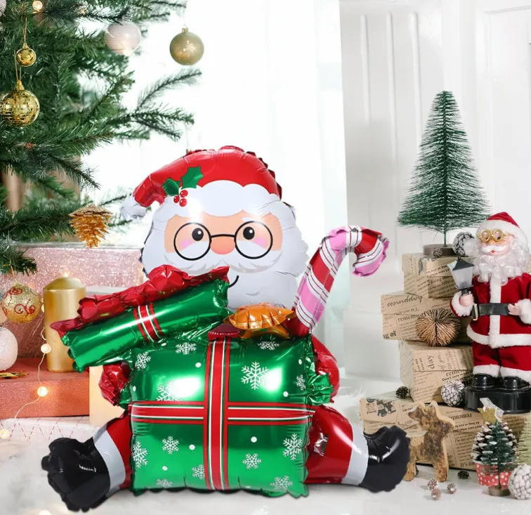Foto 2 de GLOBO METALICO CON DISEÑO NAVIDEÑO DE PAPA NOEL SENTADO SOBRE UNA CAJA DE REGALO VERDE