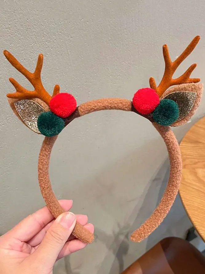 DIADEMA NAVIDEÑA CON CUERNOS DE RENO Y DETALLES DE POMPONES ROJOS